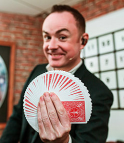 A magician holding cards