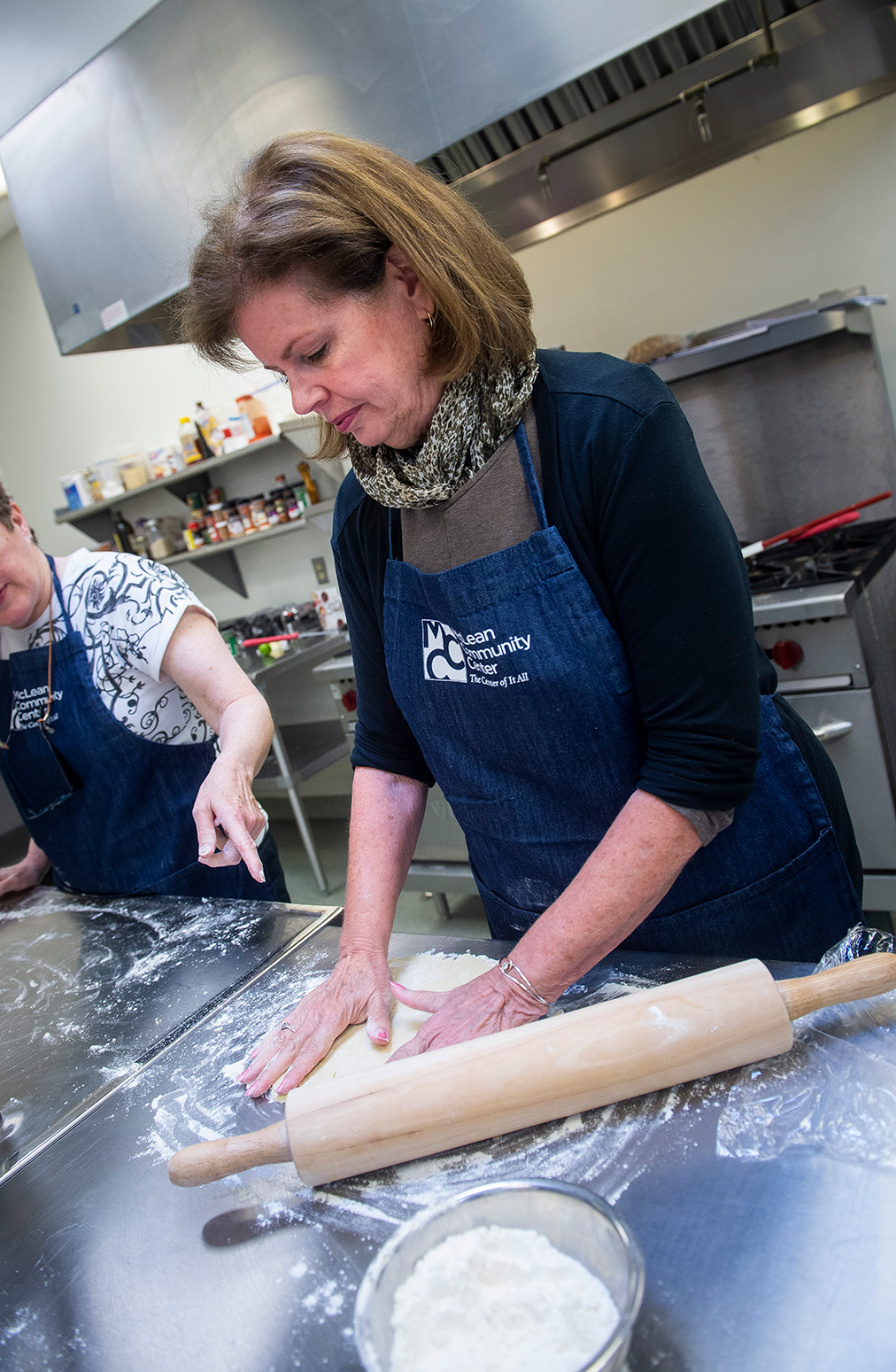 Woman rolling dough in cooking class