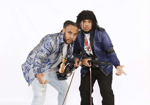 two men holding violins