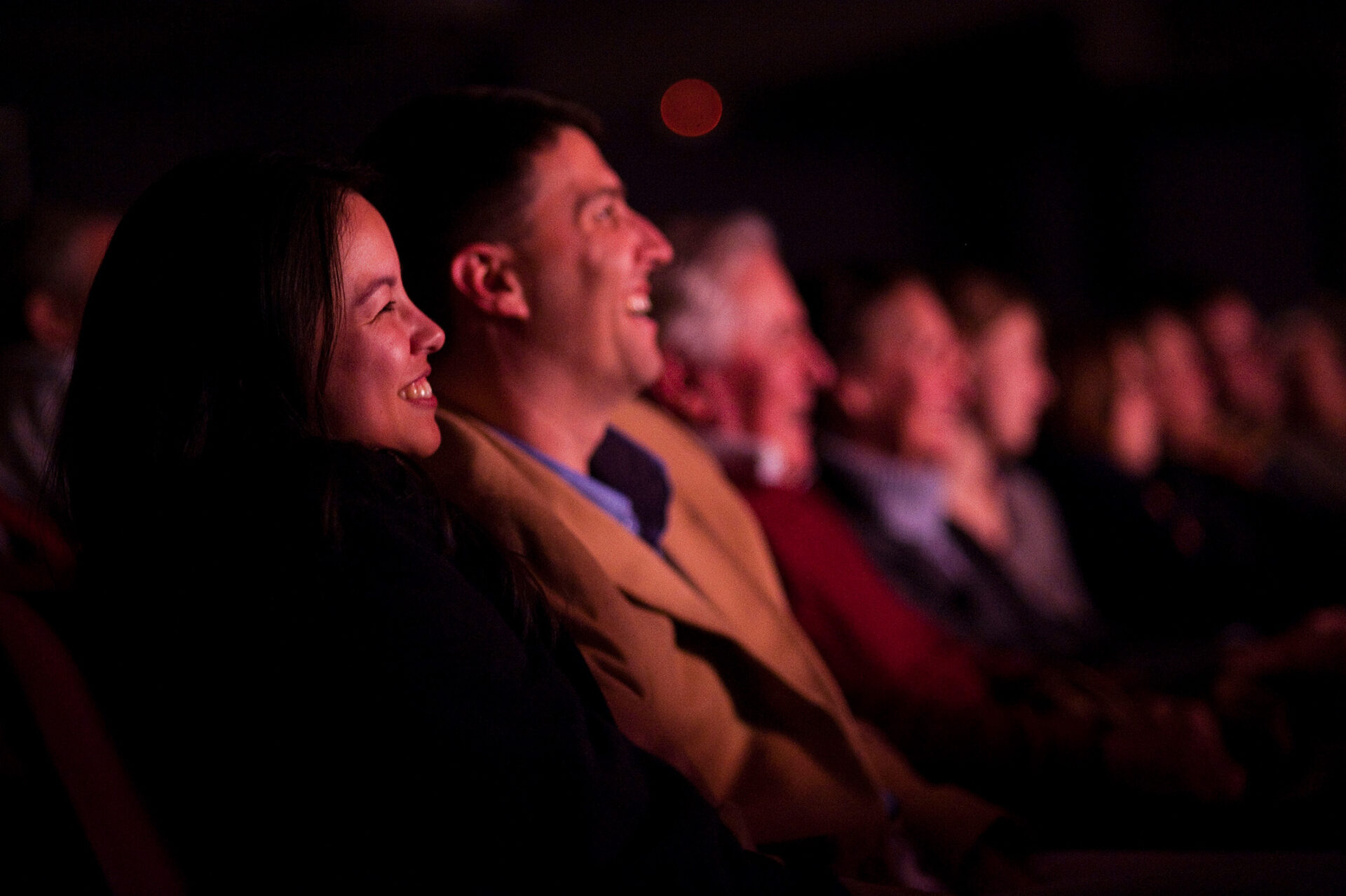 Audience laughing in the Alden Theater