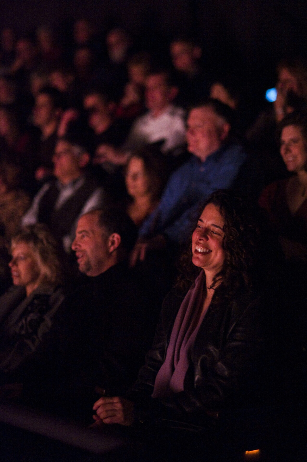 Audience laughing in the Alden Theater