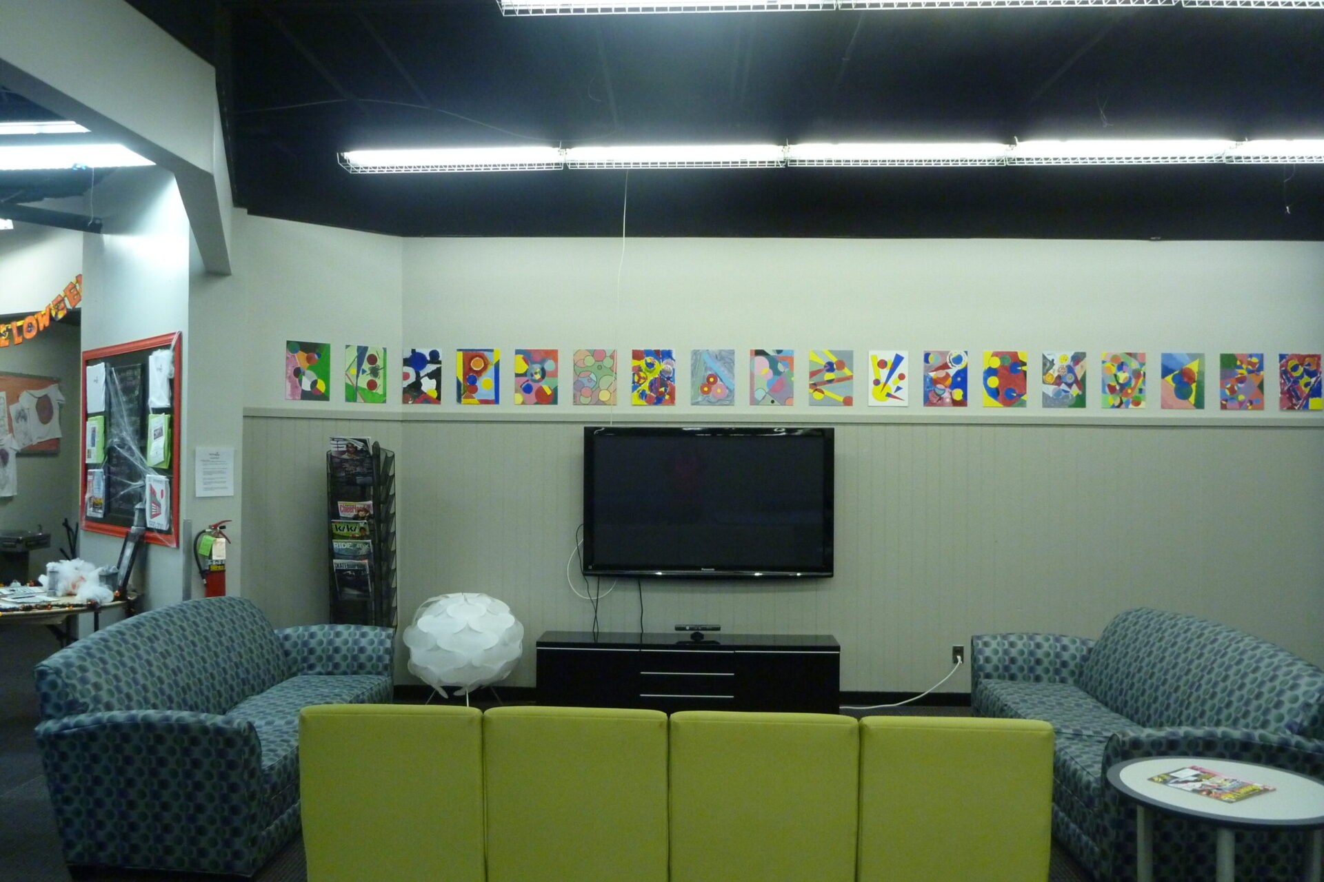 couches and a tv in the game room of the Old Firehouse Center