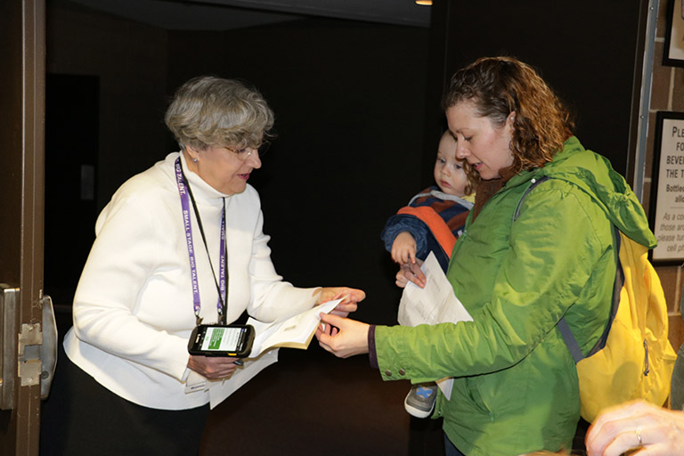 Alden-usher-volunteer An usher scanning a ticket