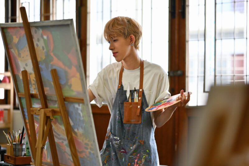 Young Asian LGBT artists doing artwork in the workshop studio.