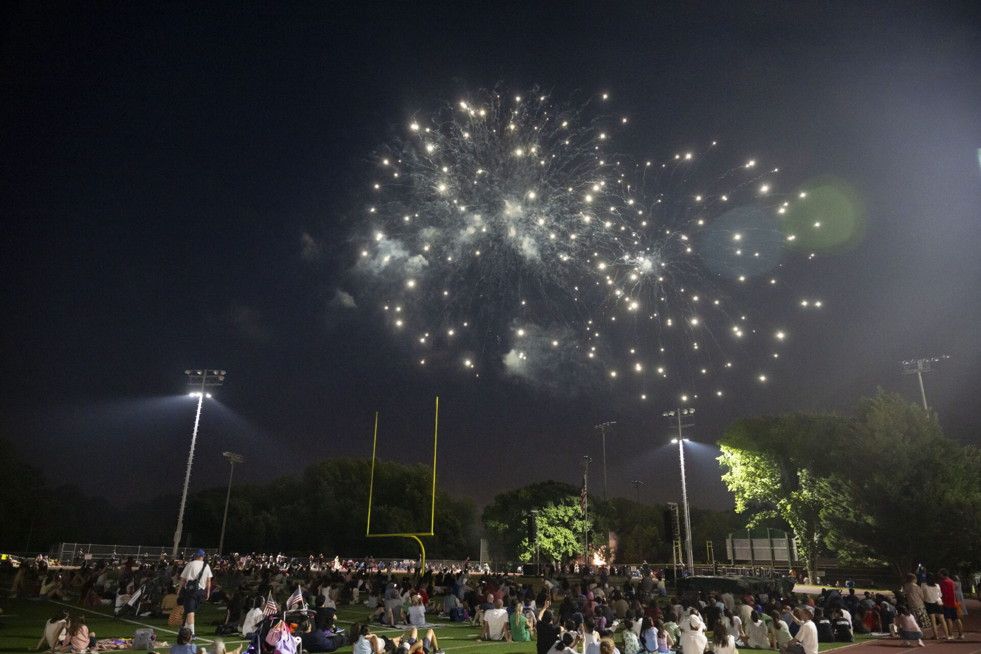 A crowd watching the firework display
