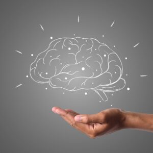 Hand holding an illustration of a brain